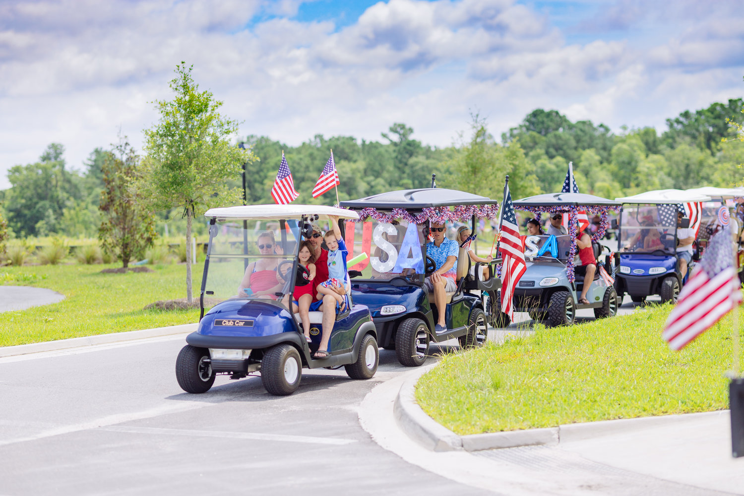 Golf carts decorated in a patriotic theme parade through Shearwater.